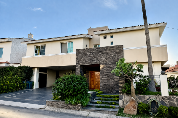 Modern Mediterranean-style house with lush landscaping